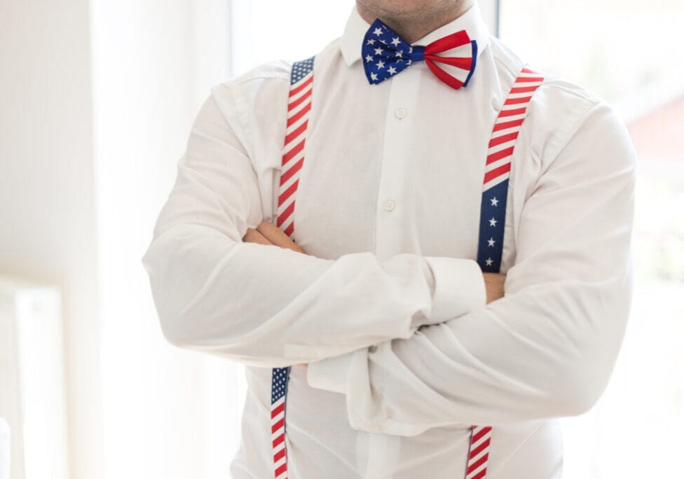 Close up of a man's neck with plaid bow tie ( american flag )